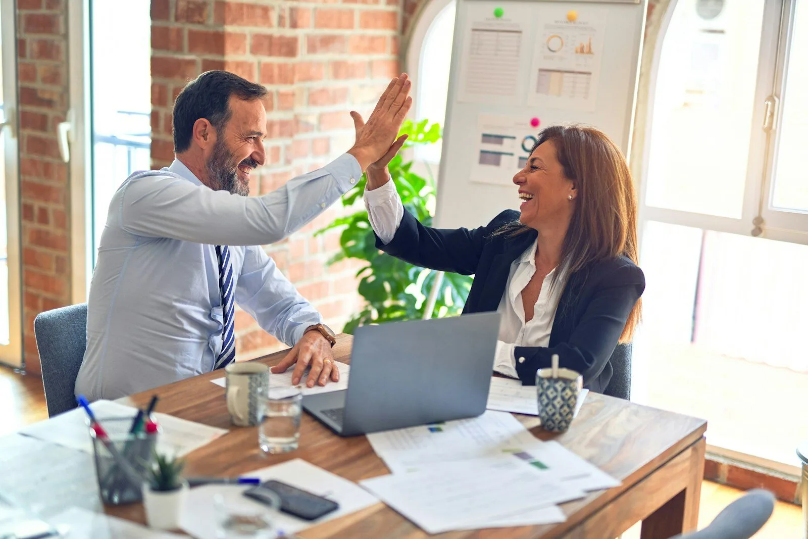 Colleagues celebrating at a desk